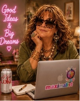 Stacie at her desk with a Diet Coke and maximalist laptop stickers
